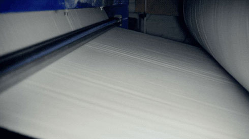 roll of paper being produced that includes a manufacturing flaw